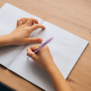 hands writing on a paper