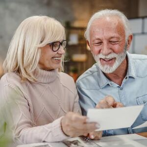 couple smiling and looking at paper